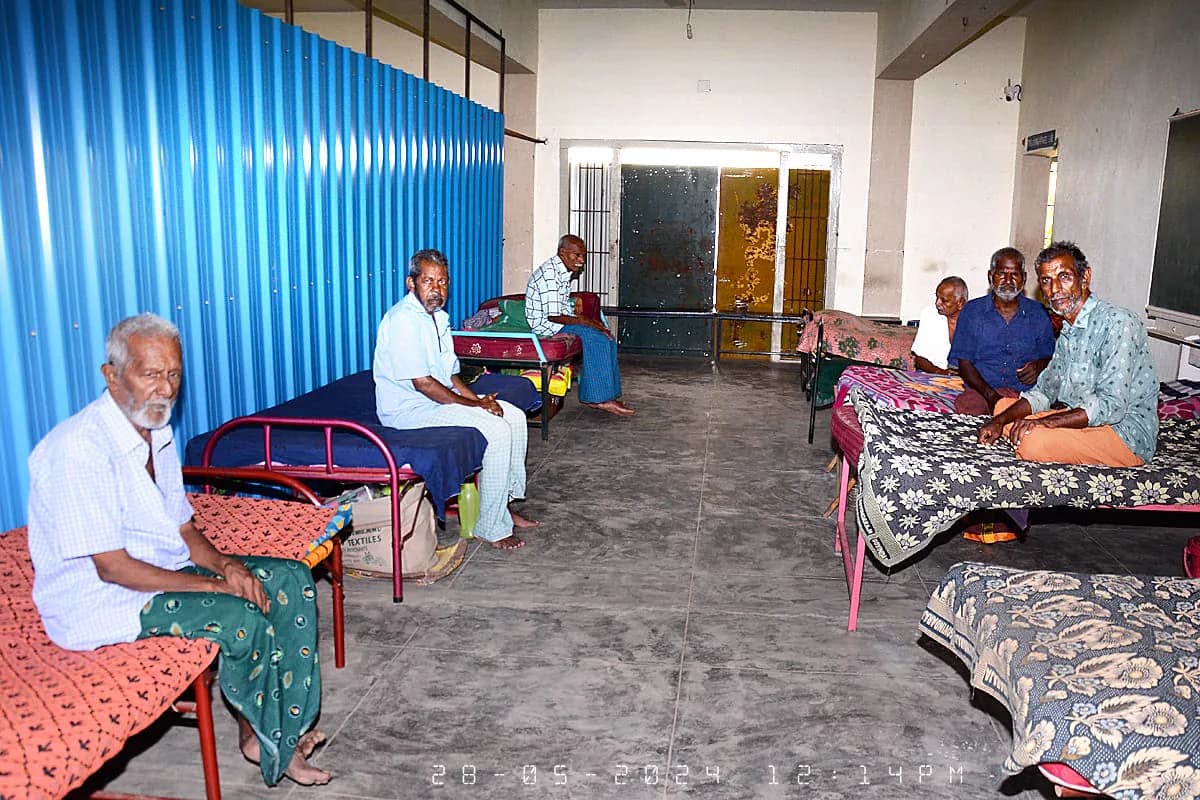 Residents resting and talking in a bright room at the home