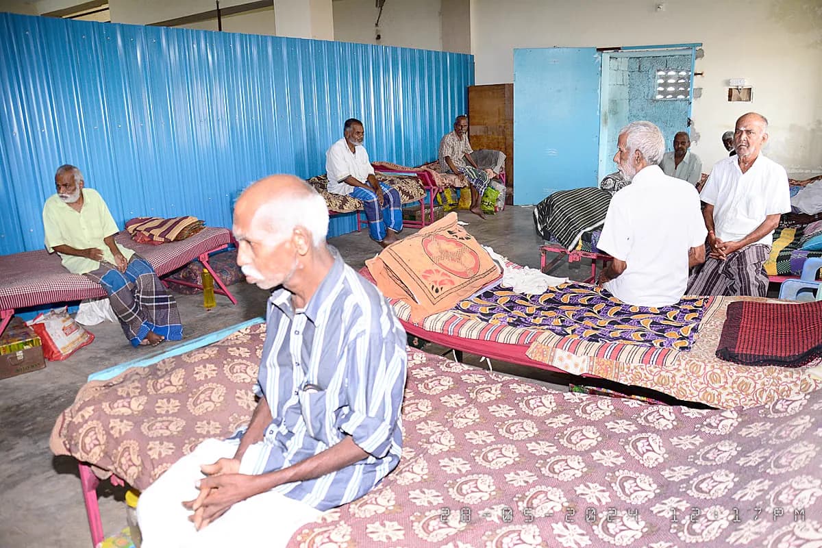 Residents seated together in a shared living room at Michael Trust